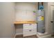Storage room with utility sink, drawers, and water heater at 21 Lake Ave, Winter Haven, FL 33880