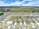 Aerial view pinpoints the property within a planned community featuring landscaped yards and modern homes at 221 Hilltop Bloom Loop, Haines City, FL 33844
