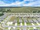 Aerial view pinpoints the property within a planned community featuring landscaped yards and modern homes at 221 Hilltop Bloom Loop, Haines City, FL 33844
