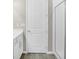 Bathroom showcasing a large walk-in shower, white vanity, and white tile flooring at 221 Hilltop Bloom Loop, Haines City, FL 33844