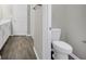 Bathroom featuring a toilet, wood look tile flooring, and a double sink vanity at 221 Hilltop Bloom Loop, Haines City, FL 33844