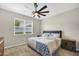 Comfortable bedroom featuring a decorative ceiling fan, plush carpeting, and a window with blinds at 221 Hilltop Bloom Loop, Haines City, FL 33844