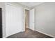 Cozy bedroom featuring neutral walls, plush carpet, and white closet doors at 221 Hilltop Bloom Loop, Haines City, FL 33844