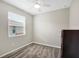 Cozy bedroom with a ceiling fan, plush carpeting, and natural light from the window at 221 Hilltop Bloom Loop, Haines City, FL 33844