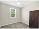 Cozy bedroom featuring neutral walls, plush carpet, window with blinds, and a dark wood wardrobe at 221 Hilltop Bloom Loop, Haines City, FL 33844