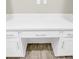A close-up of a built-in desk in white finish, showcasing the drawers and storage at 221 Hilltop Bloom Loop, Haines City, FL 33844