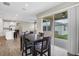 Dining area connecting to kitchen with sliding door to patio with table for four at 221 Hilltop Bloom Loop, Haines City, FL 33844