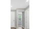 Bright entryway with wood-look flooring, neutral walls, and doorways leading to other rooms at 221 Hilltop Bloom Loop, Haines City, FL 33844