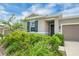 Lovely single-story home featuring a well-manicured lawn and mature shrubbery at 221 Hilltop Bloom Loop, Haines City, FL 33844