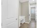 Hallway with wood-look tile flooring and a white built-in desk at 221 Hilltop Bloom Loop, Haines City, FL 33844