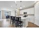 Kitchen with white cabinetry, stainless steel appliances, and modern pendant lighting at 221 Hilltop Bloom Loop, Haines City, FL 33844