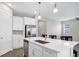 Open kitchen featuring a central island with quartz countertops and stainless steel appliances at 221 Hilltop Bloom Loop, Haines City, FL 33844