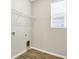Laundry room featuring wood-look tile flooring, a window, and laundry connections at 221 Hilltop Bloom Loop, Haines City, FL 33844