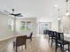 An open-concept living room with bar seating, dining area, and modern lighting at 221 Hilltop Bloom Loop, Haines City, FL 33844