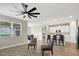 Open living area featuring tile floors, an elegant ceiling fan and adjacent modern kitchen at 221 Hilltop Bloom Loop, Haines City, FL 33844