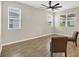Living room featuring tile flooring, multiple windows, and a ceiling fan at 221 Hilltop Bloom Loop, Haines City, FL 33844