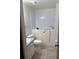 Bathroom featuring walk-in tub, toilet, and vanity with a solid surface countertop at 2235 Grand Cypress Dr # 561, Lakeland, FL 33810