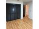 Bedroom featuring hardwood floors and a closet with dark folding doors at 2235 Grand Cypress Dr # 561, Lakeland, FL 33810