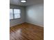 Bedroom offers wood floors and a bright window, creating a serene living space at 2235 Grand Cypress Dr # 561, Lakeland, FL 33810