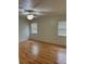 Bright bedroom features wood floors, ceiling fan, and natural light from two windows at 2235 Grand Cypress Dr # 561, Lakeland, FL 33810