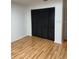 Bedroom with hardwood floors and a closet featuring dark folding doors at 2235 Grand Cypress Dr # 561, Lakeland, FL 33810