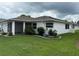 Charming home featuring a well-manicured lawn and a screened-in lanai for outdoor relaxation at 2235 Grand Cypress Dr # 561, Lakeland, FL 33810