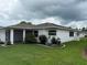 Charming home featuring a well-manicured lawn and a screened-in lanai for outdoor relaxation at 2235 Grand Cypress Dr # 561, Lakeland, FL 33810