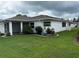 Charming home featuring a well-manicured lawn and a screened-in lanai for outdoor relaxation at 2235 Grand Cypress Dr # 561, Lakeland, FL 33810