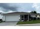 Inviting single-story home with a two-car garage, screened-in porch, and well-maintained landscaping at 2235 Grand Cypress Dr # 561, Lakeland, FL 33810