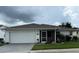 Inviting single-story home with a two-car garage, screened-in porch, and well-maintained landscaping at 2235 Grand Cypress Dr # 561, Lakeland, FL 33810