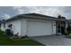 Well-maintained home featuring a spacious two-car garage, landscaped yard, and convenient screen porch at 2235 Grand Cypress Dr # 561, Lakeland, FL 33810