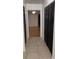 Hallway view showcases closet space and leads to a bedroom with hardwood floors at 2235 Grand Cypress Dr # 561, Lakeland, FL 33810