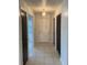 Bright hallway features neutral tile flooring and a decorative light fixture at 2235 Grand Cypress Dr # 561, Lakeland, FL 33810