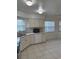 Bright kitchen featuring stainless steel appliances, white cabinets, and tile flooring at 2235 Grand Cypress Dr # 561, Lakeland, FL 33810