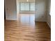 Living area featuring wood-look flooring and large window, inviting natural light at 2235 Grand Cypress Dr # 561, Lakeland, FL 33810