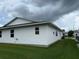 Home exterior displaying manicured lawn and white siding with view of windows and other homes at 2235 Grand Cypress Dr # 561, Lakeland, FL 33810