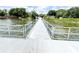 Scenic view of the lake from the dock, surrounded by lush trees and nature, offers a tranquil escape at 2517 Sunset Dr, Winter Haven, FL 33881