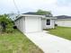 Gray single-story home with a white garage door and well-kept lawn and landscaping at 2517 Sunset Dr, Winter Haven, FL 33881