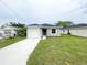 Well-maintained home with a one-car garage, green front door, and a lush lawn at 2517 Sunset Dr, Winter Haven, FL 33881