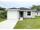 Charming single-story home featuring a one-car garage, green front door, and fresh landscaping at 2517 Sunset Dr, Winter Haven, FL 33881