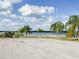 A scenic lake view surrounded by lush palm trees on a sunny day at 2517 Sunset Dr, Winter Haven, FL 33881