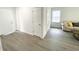 Bright living room with gray wood-look flooring, and neutral decor at 2517 Sunset Dr, Winter Haven, FL 33881