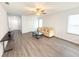 Spacious living room with neutral color palette, modern furnishings, and gray wood-look flooring at 2517 Sunset Dr, Winter Haven, FL 33881
