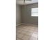 Cozy bedroom with tile flooring, a window for natural light, and neutral-colored walls at 2708 Dixie Rd, Lakeland, FL 33801