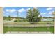 View from the backyard balcony with glass railings overlooking the lawn at 2736 Sunrise Landing Ln, Lakeland, FL 33812