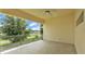 Spacious covered balcony with glass railings and a ceiling fan at 2736 Sunrise Landing Ln, Lakeland, FL 33812