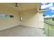 Large covered balcony with a ceiling fan, glass railings, and outdoor lighting at 2736 Sunrise Landing Ln, Lakeland, FL 33812
