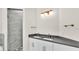 Bright bathroom features a double sink vanity with white cabinetry and a glass-enclosed shower at 2736 Sunrise Landing Ln, Lakeland, FL 33812