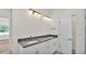 Bathroom featuring double sinks, modern lighting, and a neutral color palette at 2736 Sunrise Landing Ln, Lakeland, FL 33812
