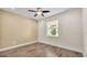 Bedroom with ceiling fan, hardwood floors, and ample natural light at 2736 Sunrise Landing Ln, Lakeland, FL 33812